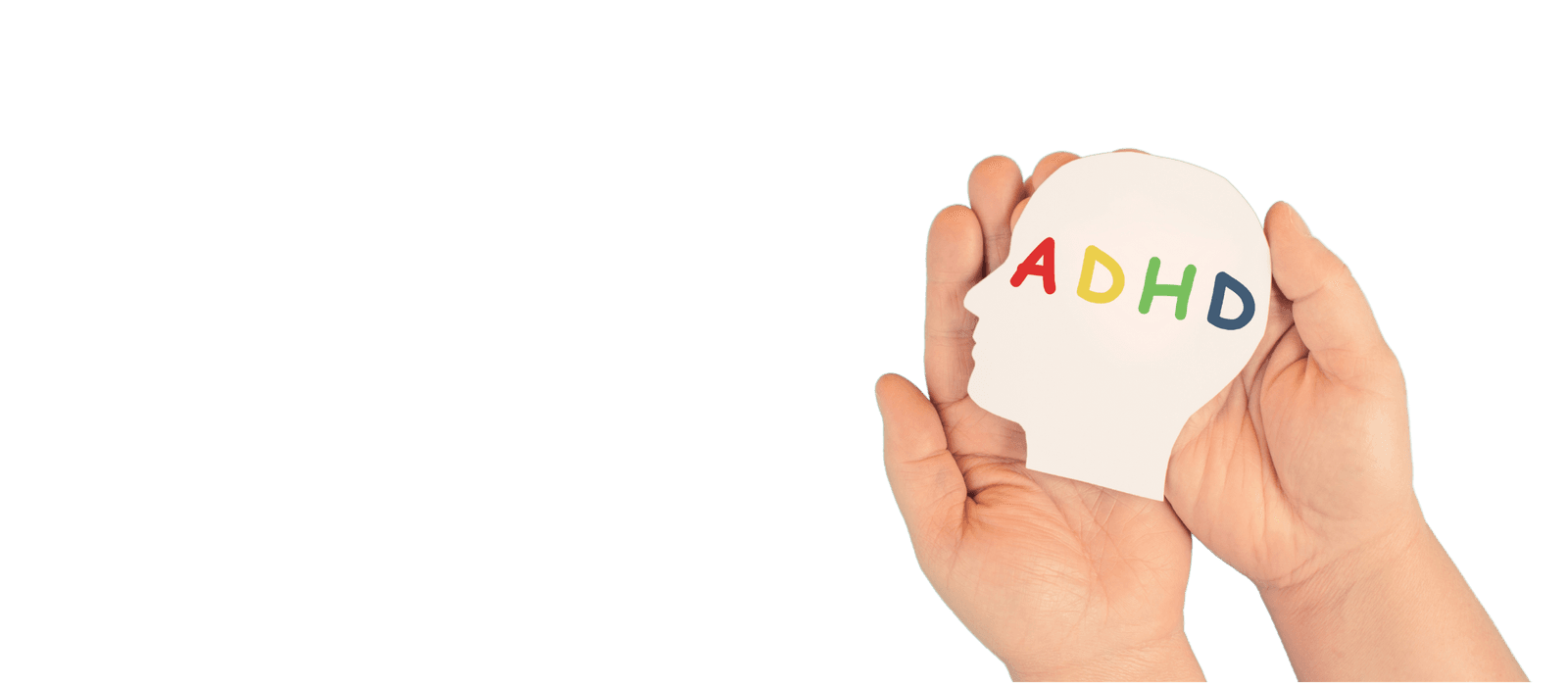A pair of hands holding a paper cut-out of a head with the letters ADHD across it.